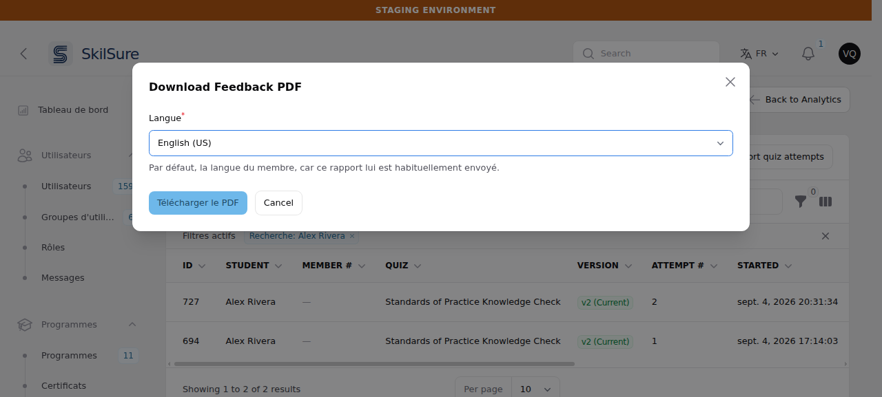 Download Feedback PDF dialog on an admin panel running in French — the surrounding menu reads Tableau de bord, Utilisateurs, Programmes — with a required "Langue" select showing English (US), the hint "Par défaut, la langue du membre, car ce rapport lui est habituellement envoyé." and a "Télécharger le PDF" button. The attempts table behind it lists Alex Rivera's attempts.